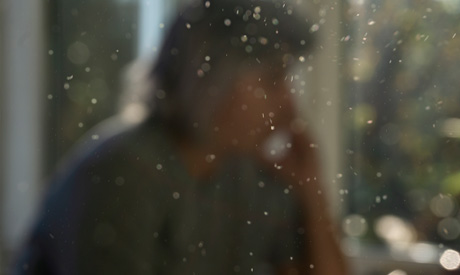 Airborne dust particles with person in the background